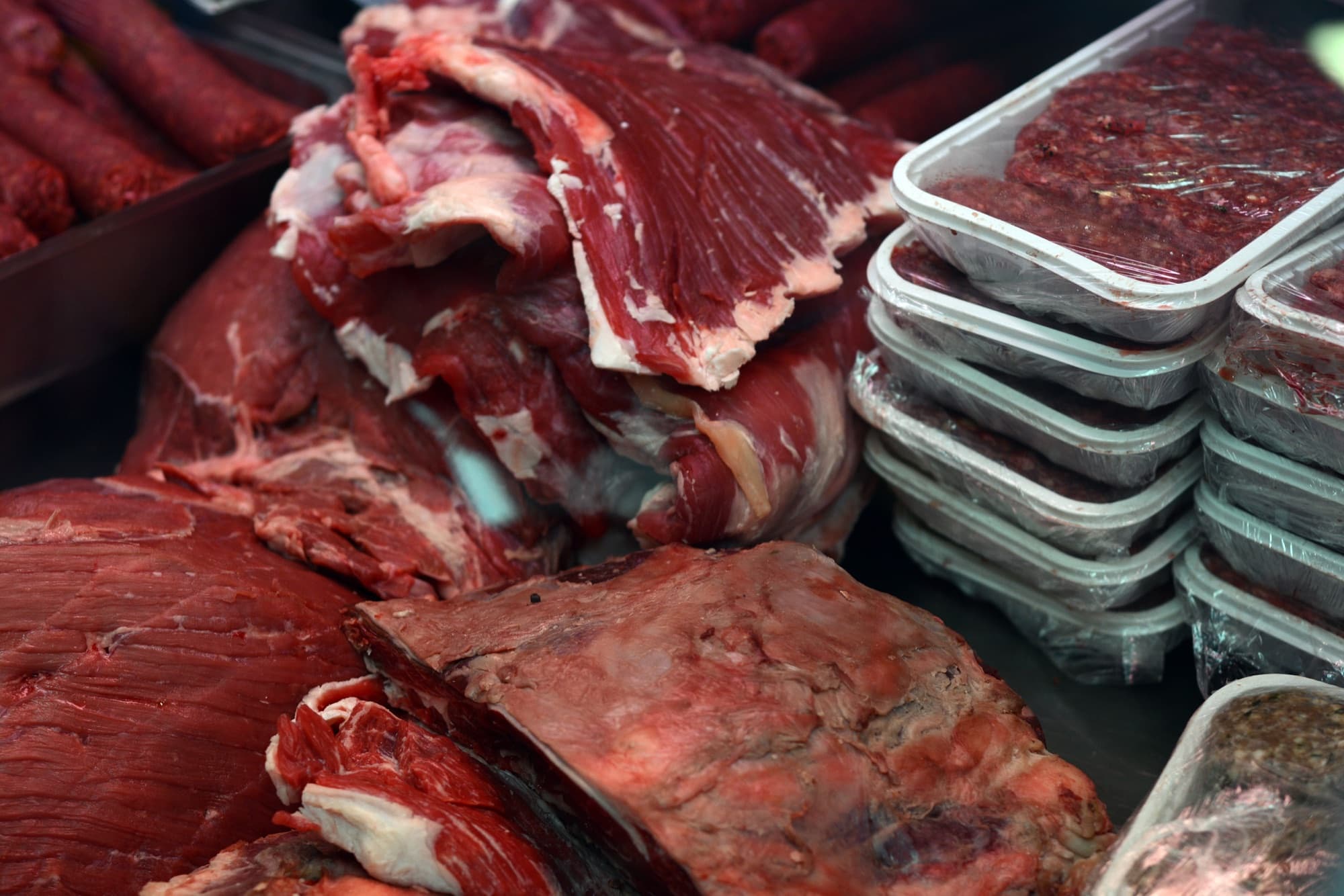Cuts of meat displayed at a butcher shop counter.